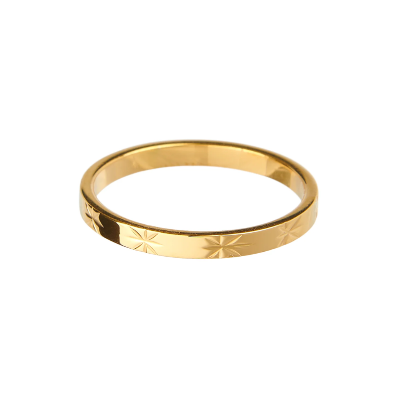 Gold ring with engraved design on a white background