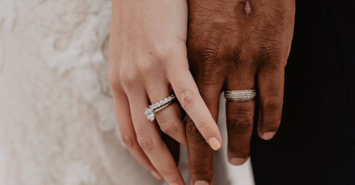 two people holding hands while wearing eternity band rings