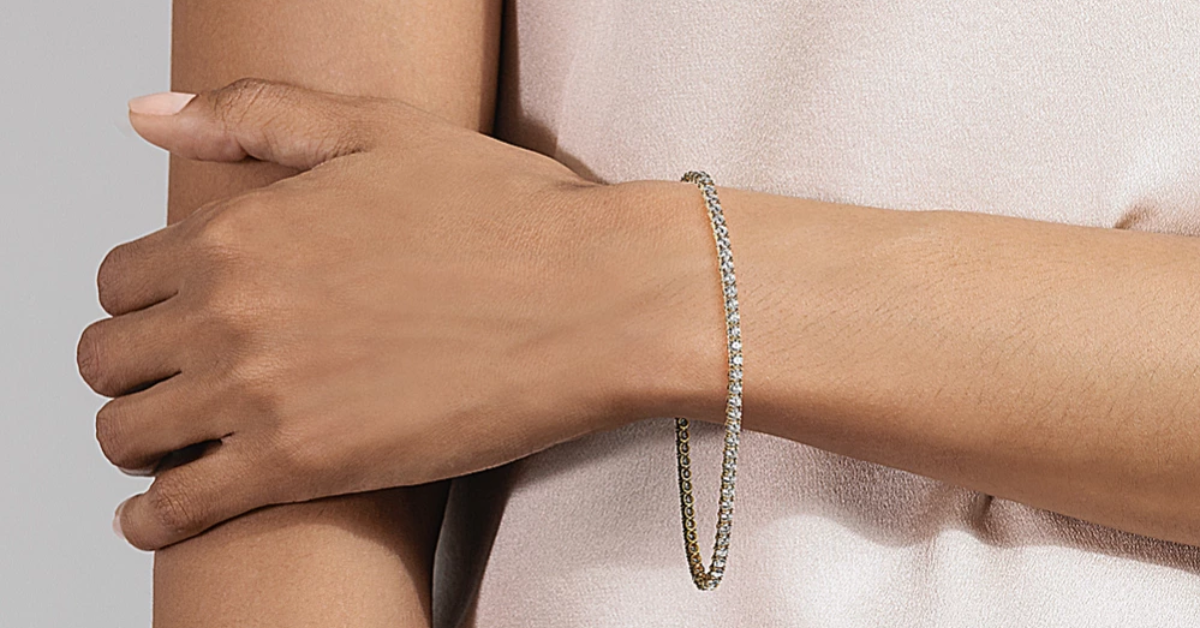 A woman holding her arm while wearing a tennis bracelet