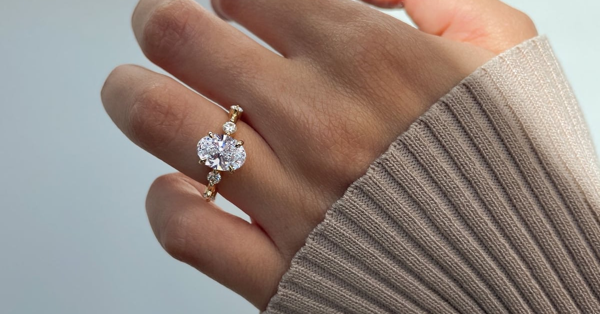 A woman wearing a hand crafted solitaire diamond ring