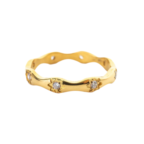 Gold ring with diamond accents on a white background