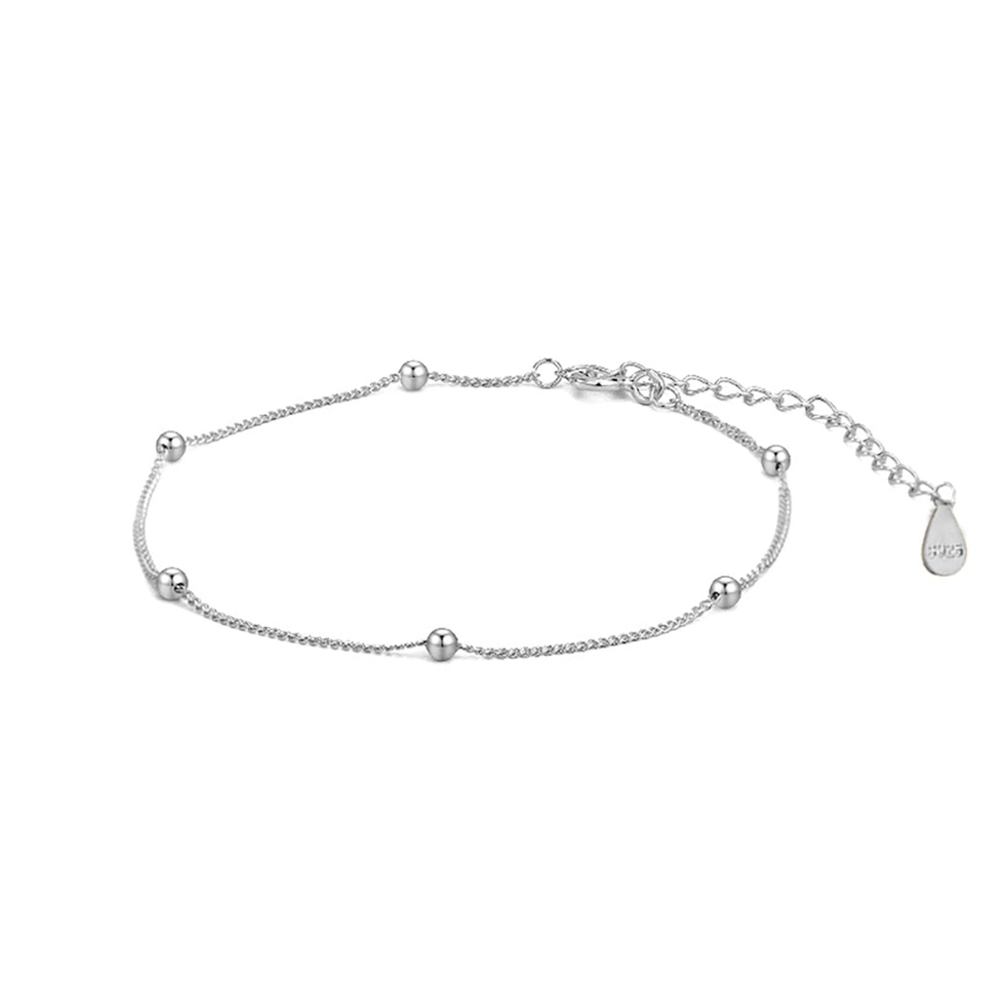 Silver bracelet with small beads on a white background