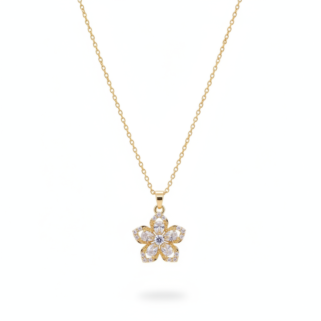 Gold necklace with white flower pendant on white background