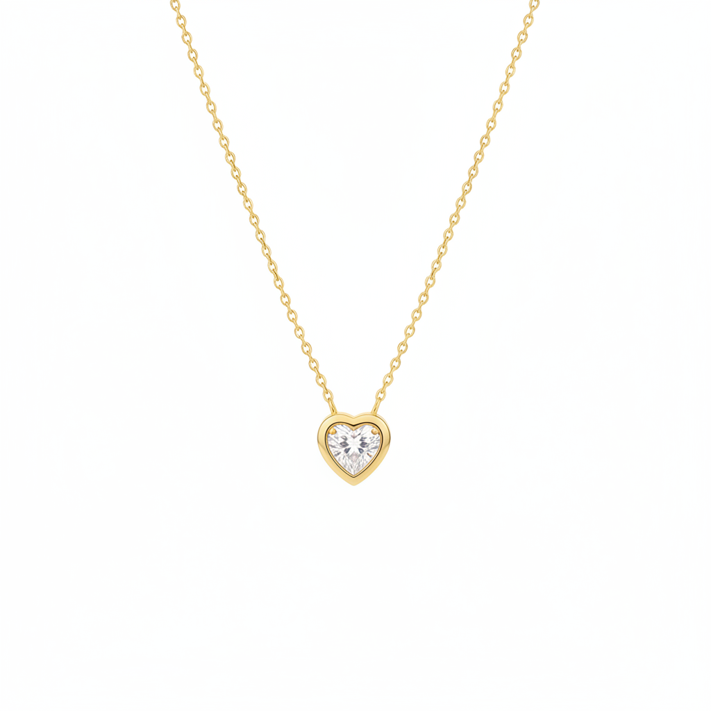 Gold necklace with white heart pendant on white background