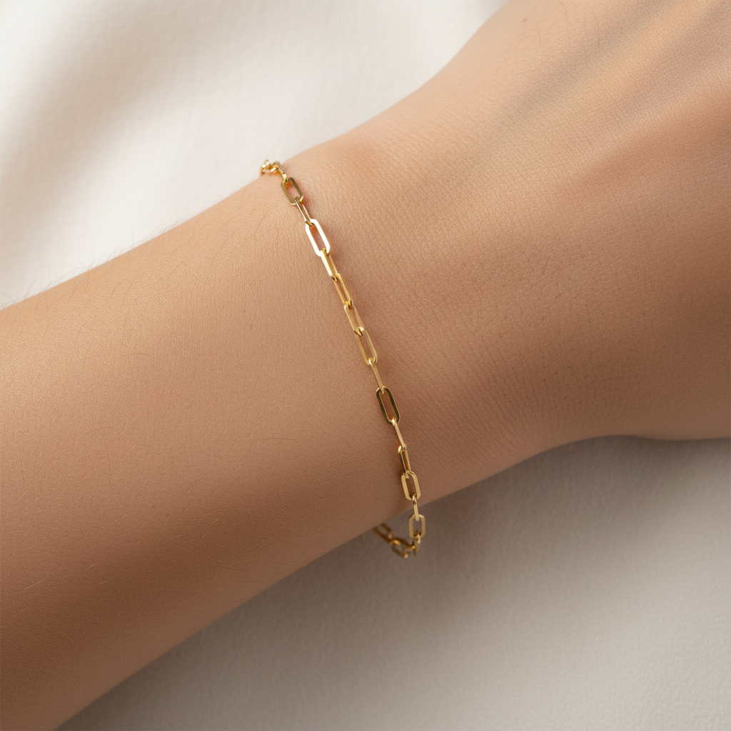 Gold paperclip bracelet worn on wrist