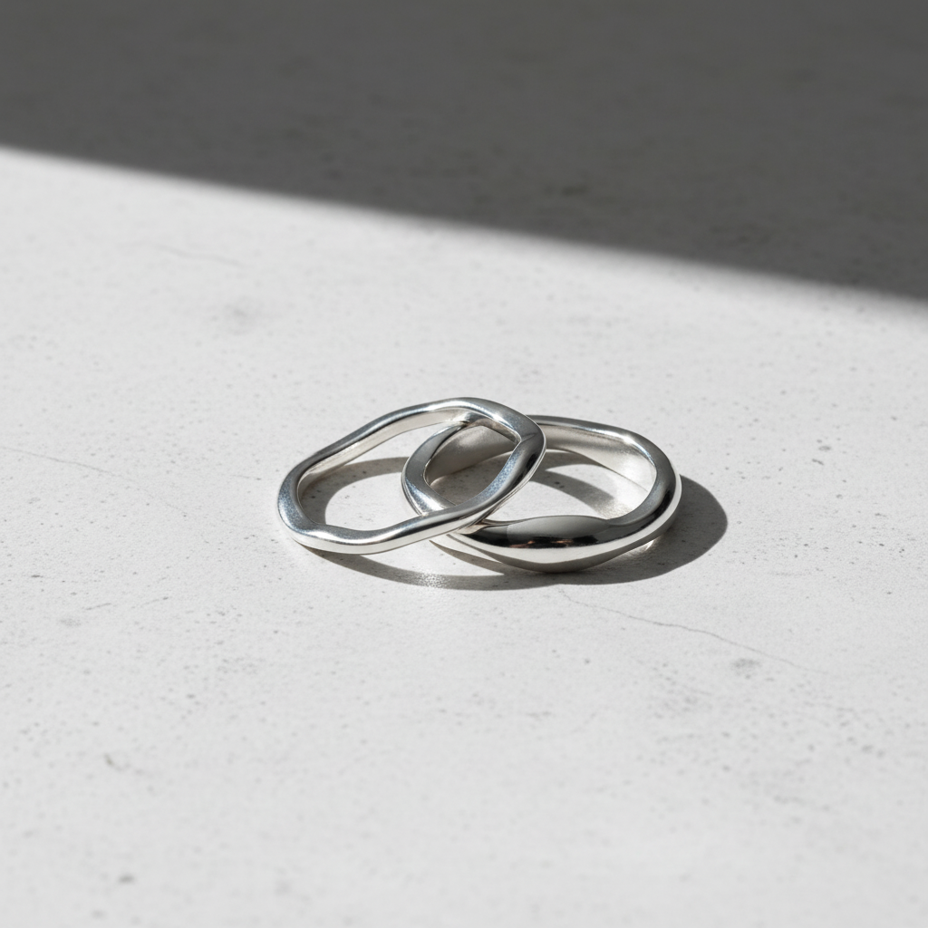 Lifestyle image of two silver stackable rings