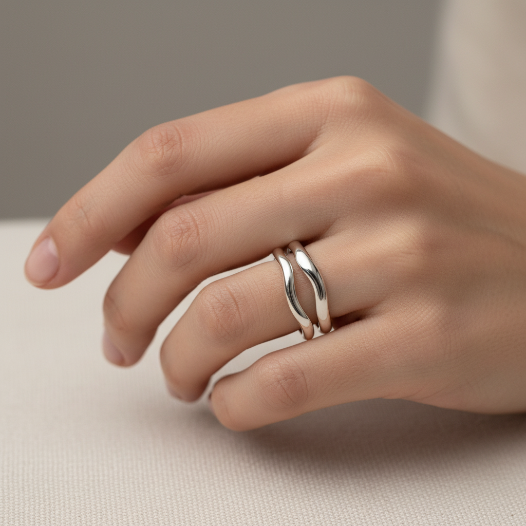 Person wearing two silver stackable rings