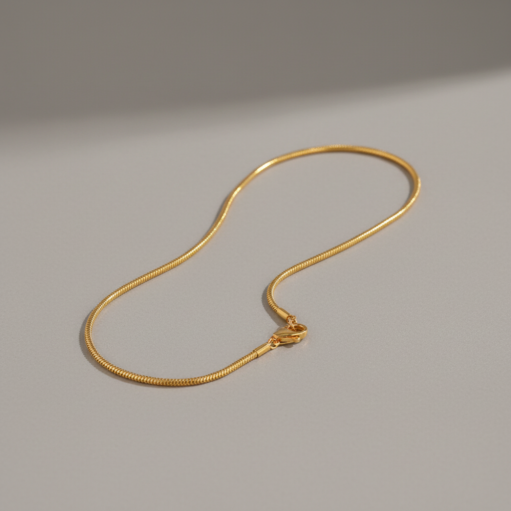 Single gold bracelet on grey background