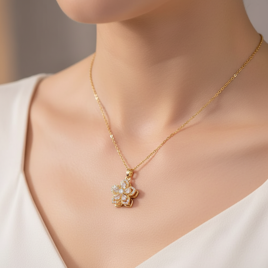 Woman wearing gold necklace with white flower pendant - neck focus